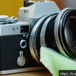 Home 18 아날로그 카메라 복원 - A close-up image of an old analog camera being carefully cleaned: a soft brush gently dusting the ca...